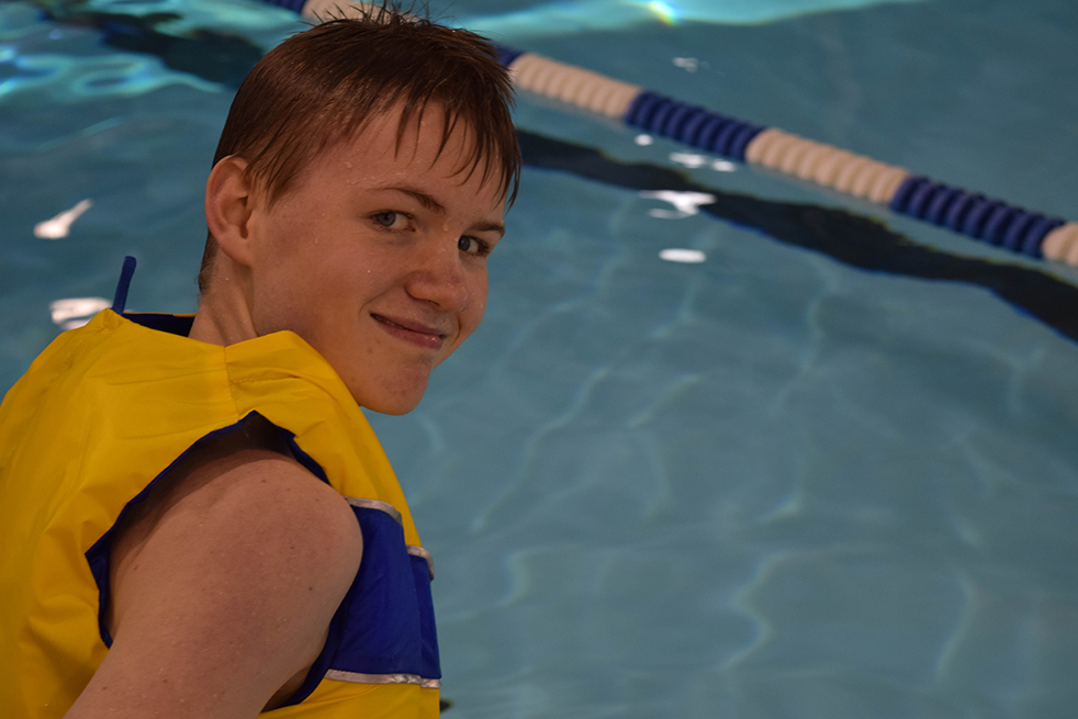 Swimmer in a Yellow Life Jacket Looking over Her Shoulder