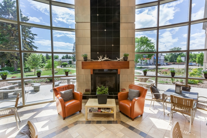 Two Orange Chairs in Front of a Fireplace