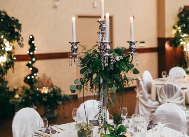 Elaborate Centerpiece Involving a Candelabra and Greenery